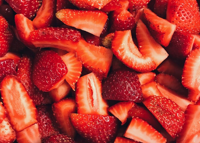 A pile of sliced strawberries.