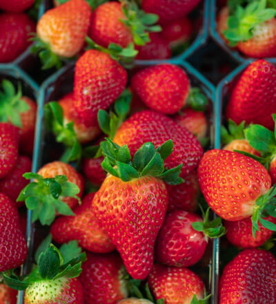 Plastic containers full of strawberries.